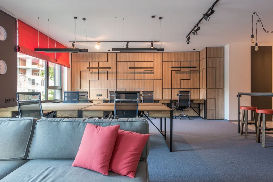 A contemporary workspace with pendant lights and ceiling track lighting.